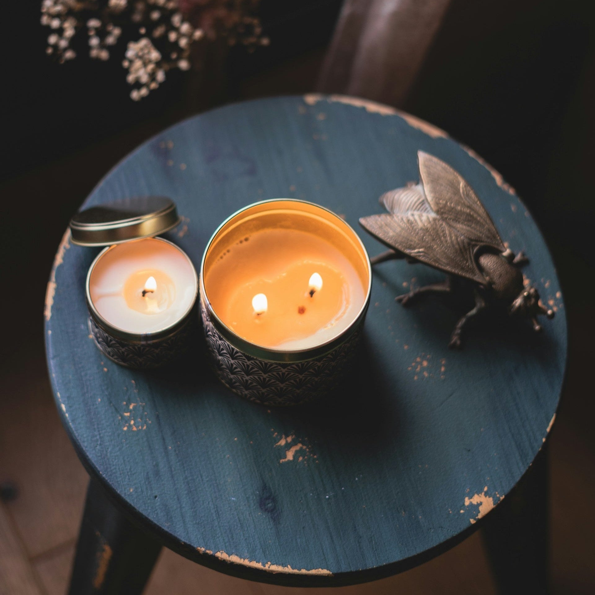 Image of two lit candles on a table by Sebastien Chiron from Unsplash