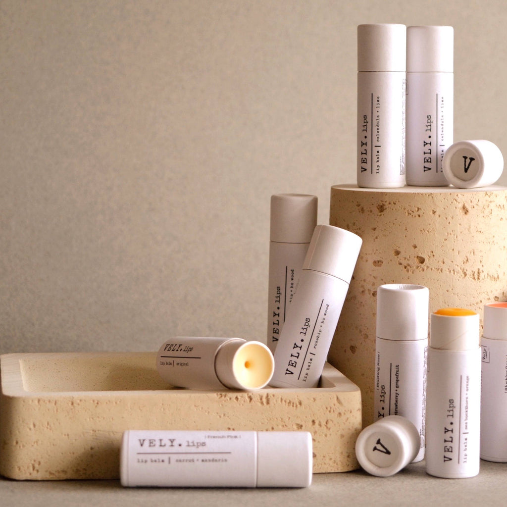 Collection of VELY lip balm products on a neutral background