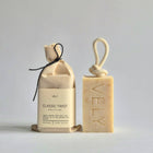 Vely soap packaging with a bar of soap and a cotton pouch on a light gray background