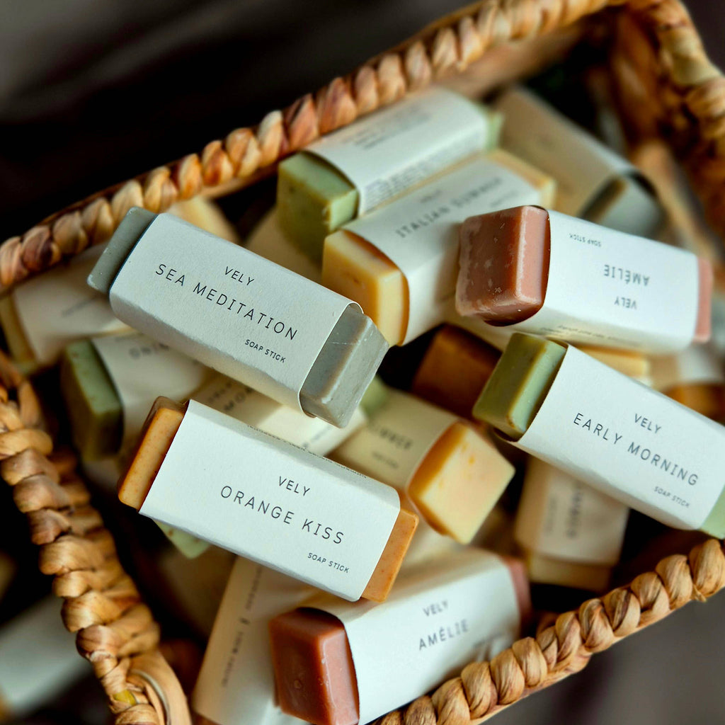 Assorted bars of soap in a wicker basket with visible labels.