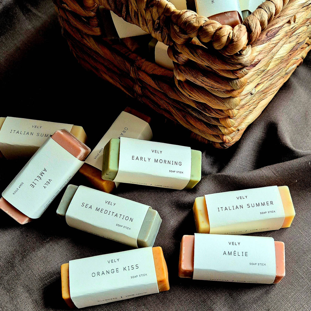 Assorted bars of VELY soap with visible branding on a brown fabric background