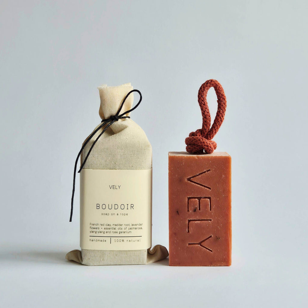 Red french clay boudoir soap on a rope, shown with cotton bag