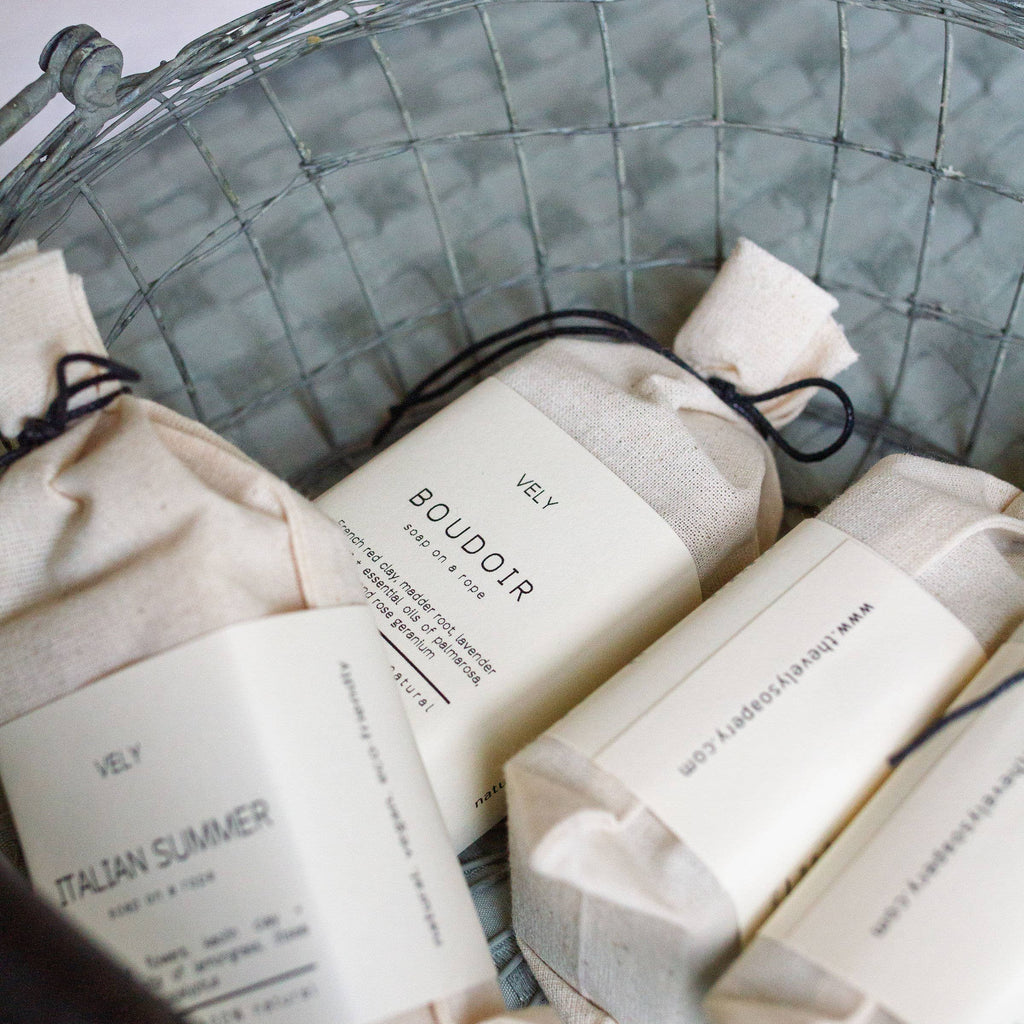 Bars of VELY soap with labels in a woven basket