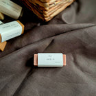 Bar of VELY soap with 'Amelie' branding on a brown fabric background