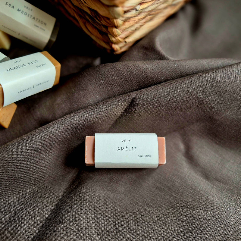 Bar of VELY soap with 'Amelie' branding on a brown fabric background