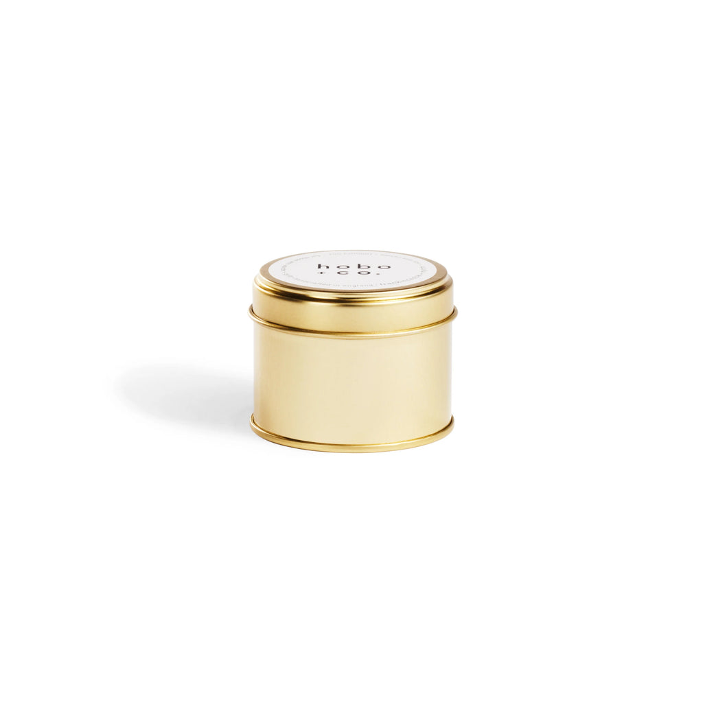 Gold cylindrical tin with a white label on a white background